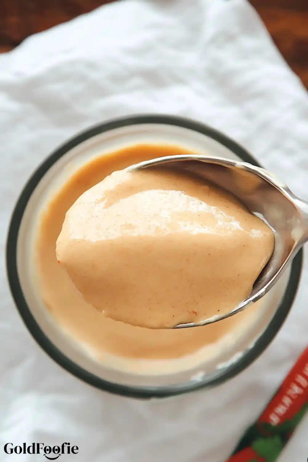 Batter for Red Lentil Tortillas Spoon scooping smooth red lentil batter from a glass jar
