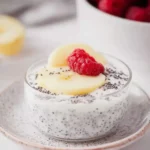 Glass bowl of chia yogurt topped with fruit