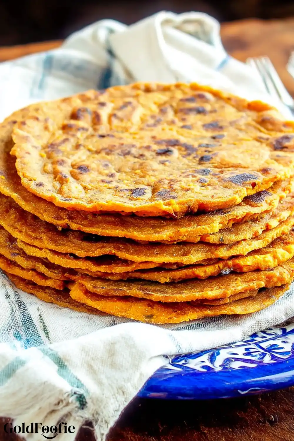 Easy 3-Ingredient Sweet Potato Tortillas 6 Stack of golden sweet potato tortillas on a white and blue towel