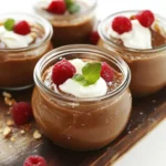 Glass jars with chocolate chia pudding, berries, and mint