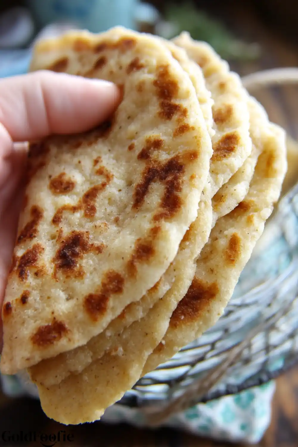 Flexible Almond Flour Tortillas – Perfect for Wraps Hand holding stack of flexible almond tortillas