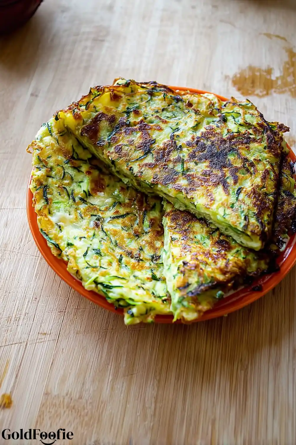 Freshly Cooked Keto Zucchini Tortillas Zucchini tortillas stacked and cut on an orange plate