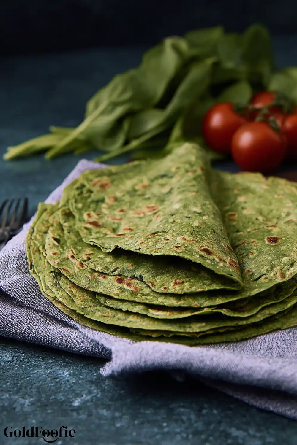 Easy Grain-Free Spinach Tortillas 6 Close-up of grain-free spinach tortillas stacked on a cloth napkin