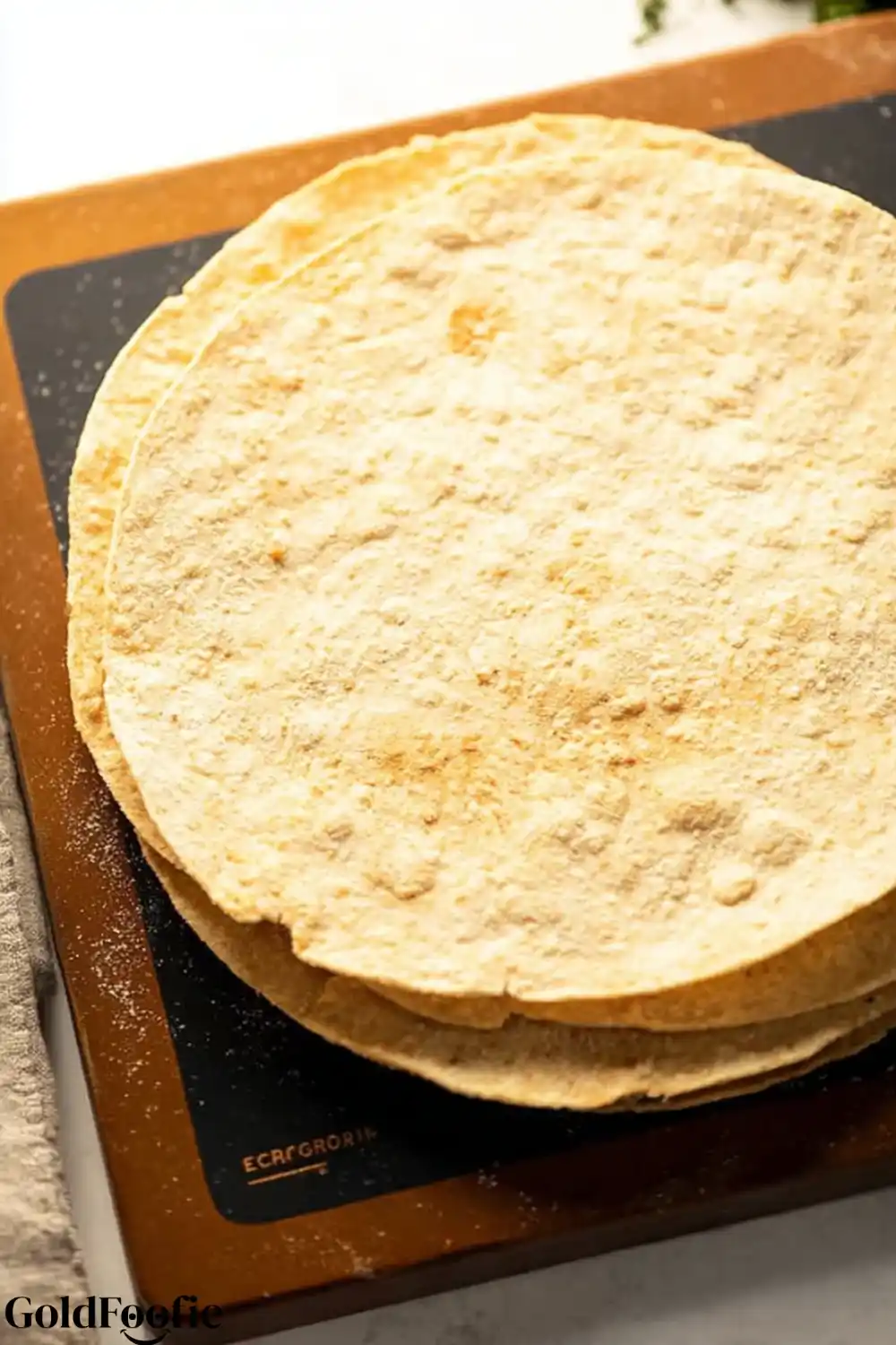 Keto-Friendly Tortilla Stack Stack of low-carb tortillas on a cutting board