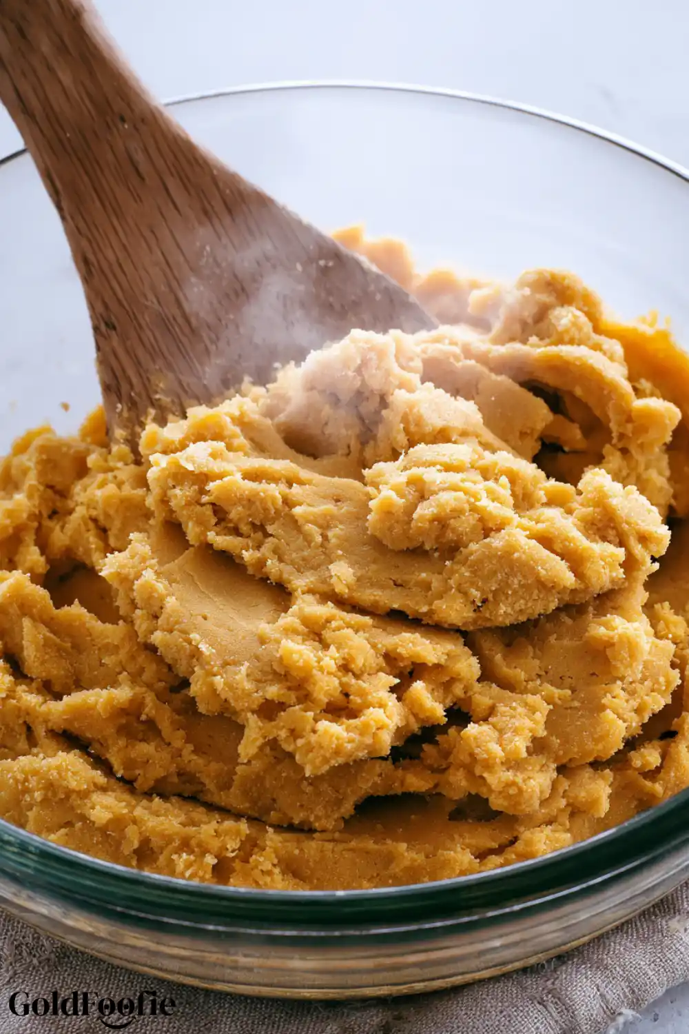 Mixing the Dough for Sweet Potato Tortillas Mashed sweet potato tortilla dough being stirred with a wooden spoon