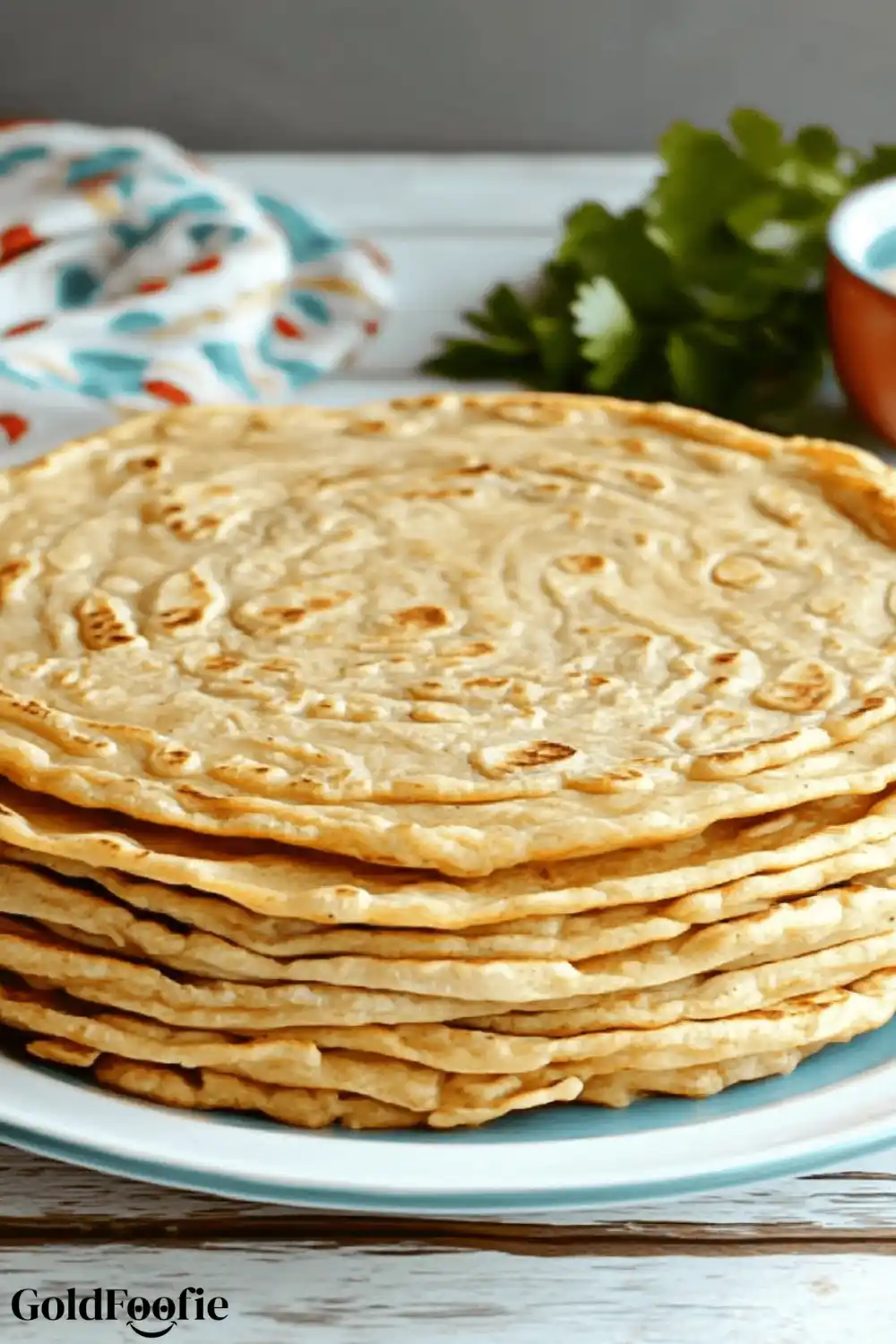 1-Ingredient Red Lentil Tortillas That Work 6 Foldable red lentil tortillas stacked on a plate with a tea towel in the background