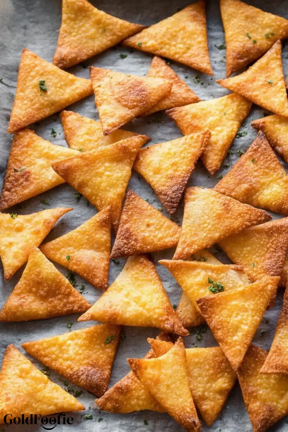 Best Homemade Low-Carb Tortilla Chips Recipe 6 Golden fried keto tortilla chips sprinkled with herbs on parchment