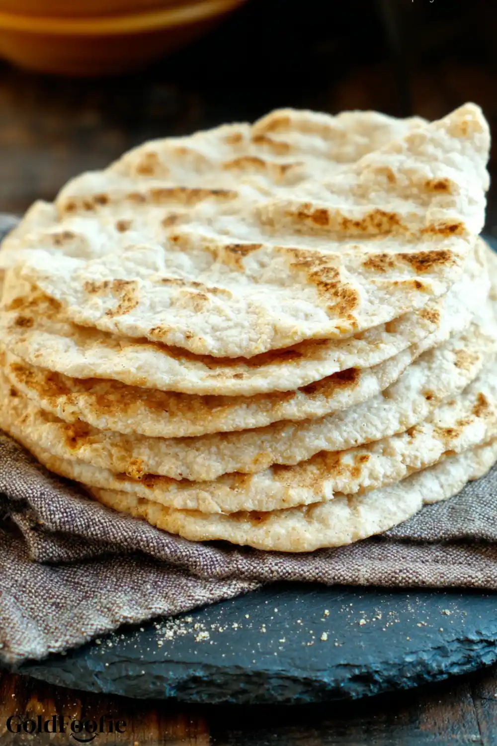 2 Ingredient Coconut Flour Tortillas Recipe 6 Stack of homemade coconut flour tortillas on a rustic black slate