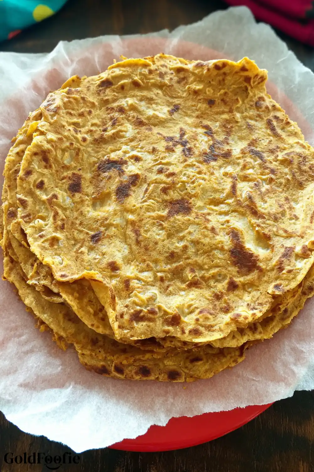 Easy 2-Ingredient Chickpea Flour Tortillas Recipe 6 Stack of golden-brown chickpea tortillas on a red plate