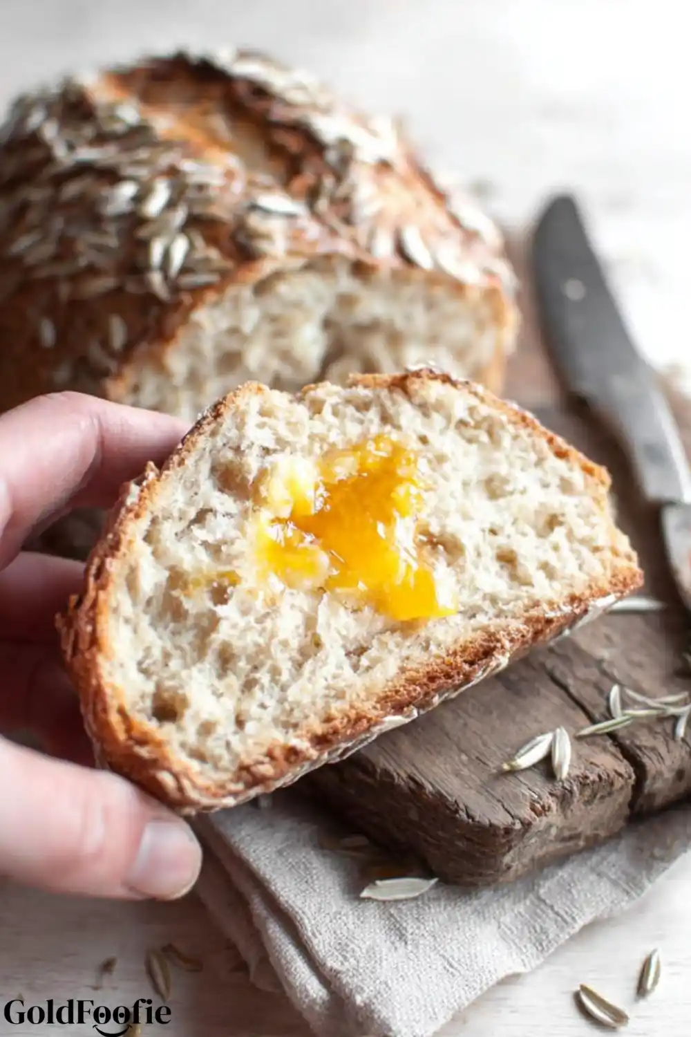 A Perfect Slice - Diabetic bread recipes A hand holding a slice of fresh Diabetic bread recipes with a pat of golden butter or jam on it.