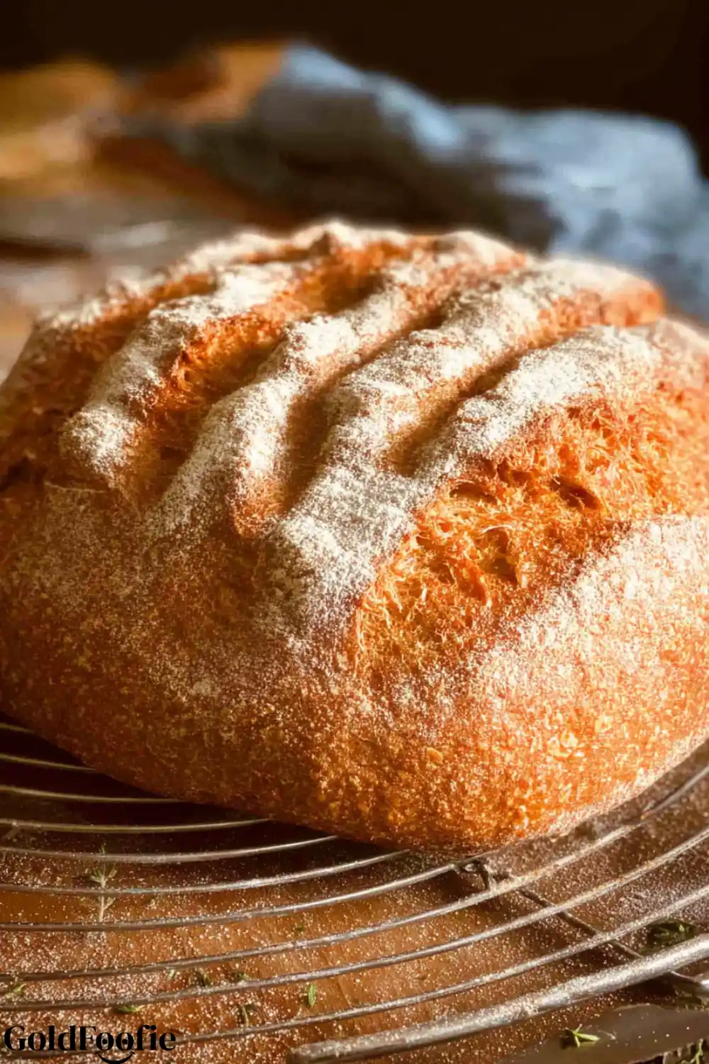 Artisan Psyllium Husk Bread A round loaf of golden-brown psyllium husk bread cooling on a wire rack.