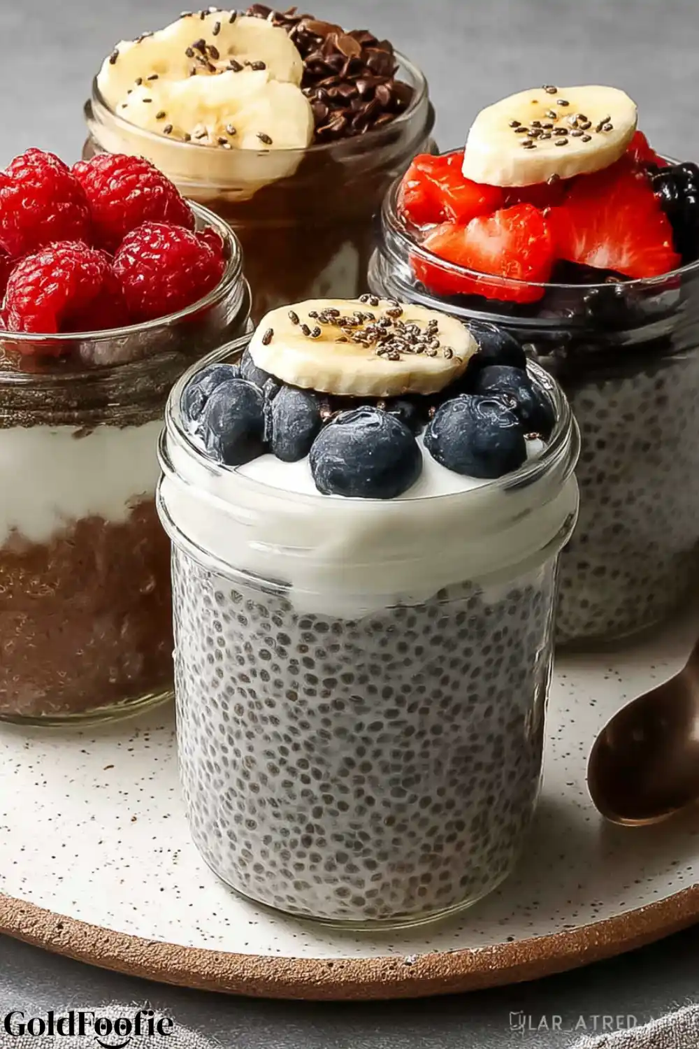 Chia Pudding with Banana and Berry Toppings Creamy chia puddings topped with bananas, raspberries, and blueberries