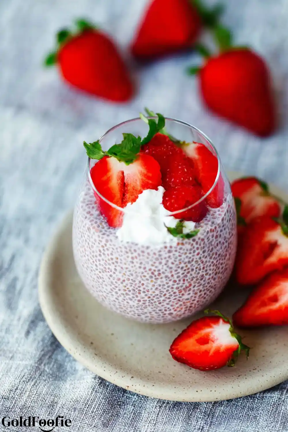 Classic Strawberry Chia Pudding Strawberry chia pudding in a glass on a beige plate