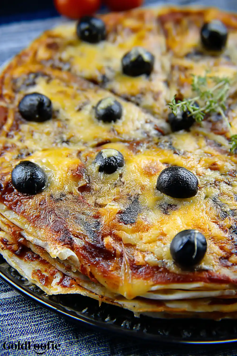 Close-up of Cheese Melt on Tortilla Pizza Melting cheese and olives on stacked pizza with low carb tortilla