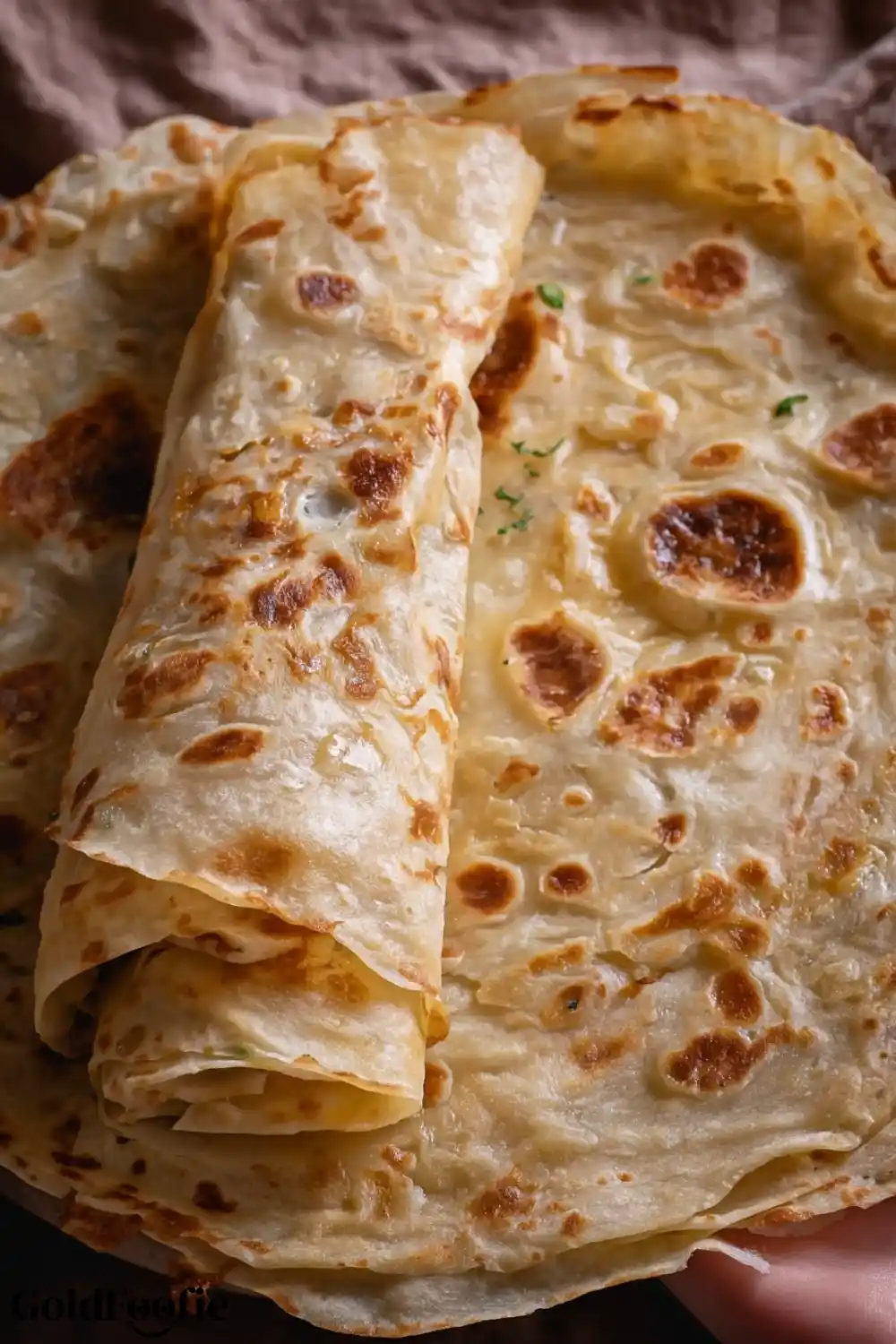 Flaky and Foldable Burrito Tortilla Close-Up Rolled burrito tortillas stacked over each other with flaky