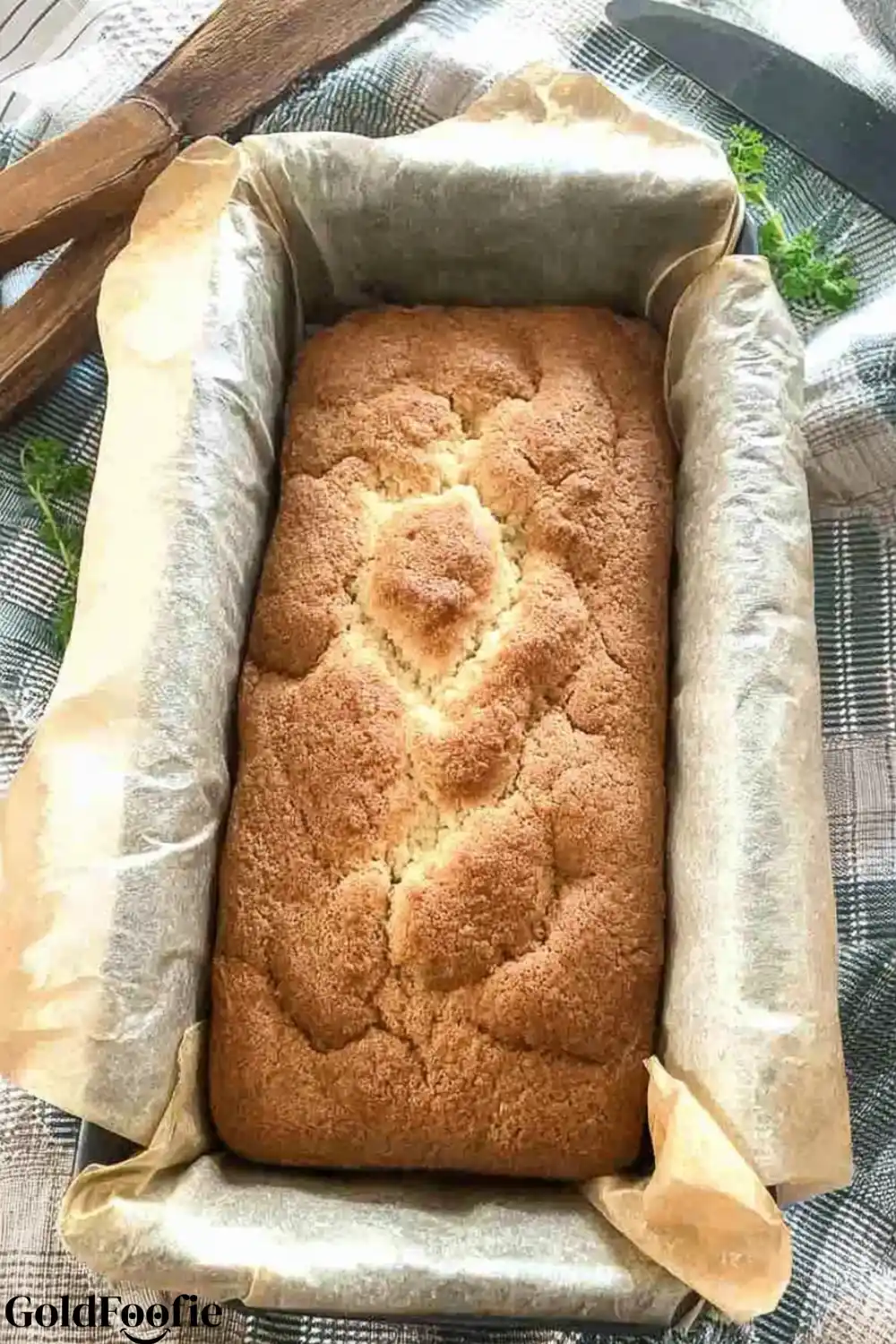 Fresh From the Oven Lupin flour Bread A freshly baked golden loaf of lupin flour bread in a parchment-lined pan.