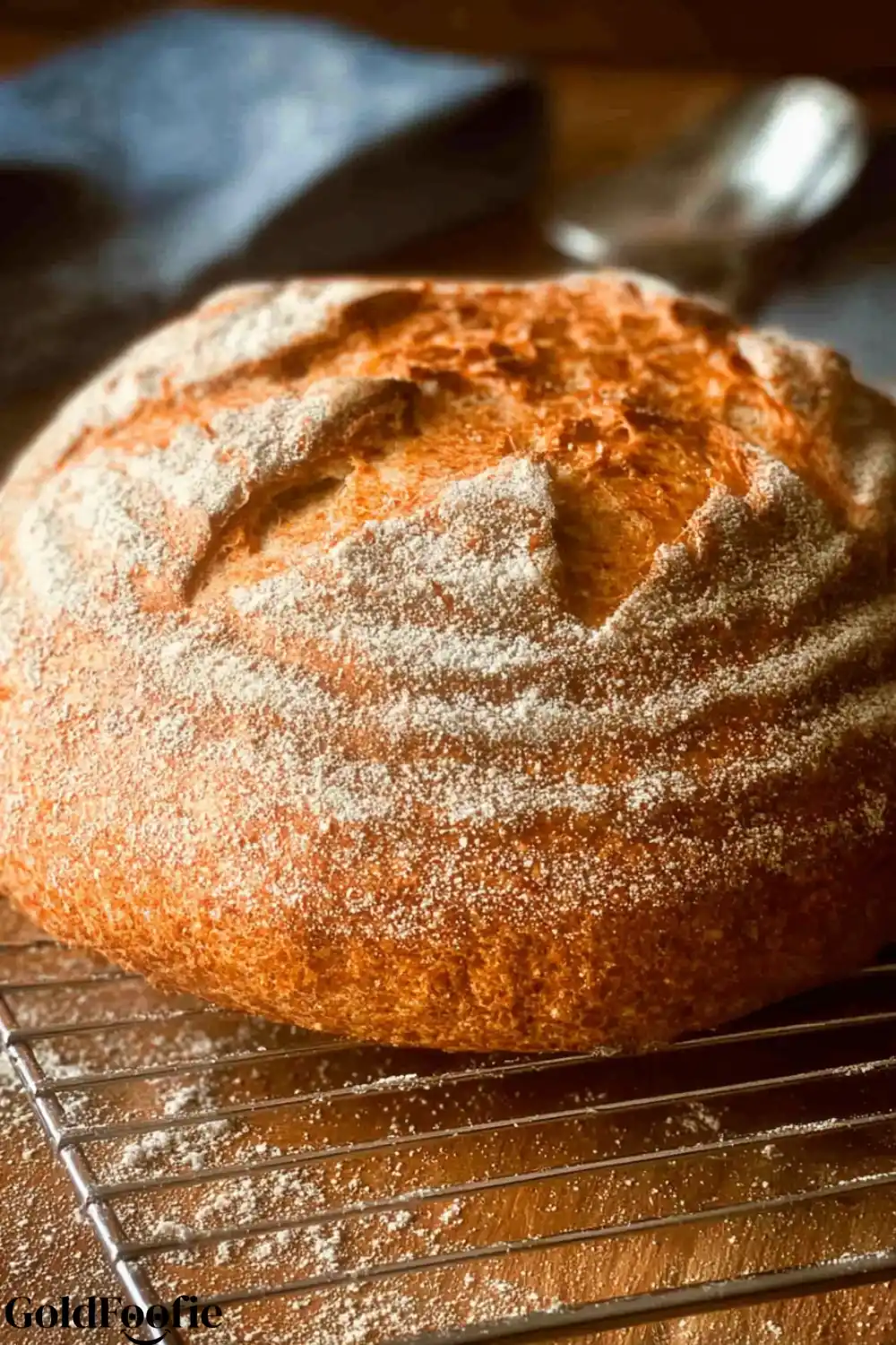 Psyllium Husk Bread No Fail Guide for Every Diet 5 A side view of a golden, round psyllium husk bread loaf on a cooling rack.