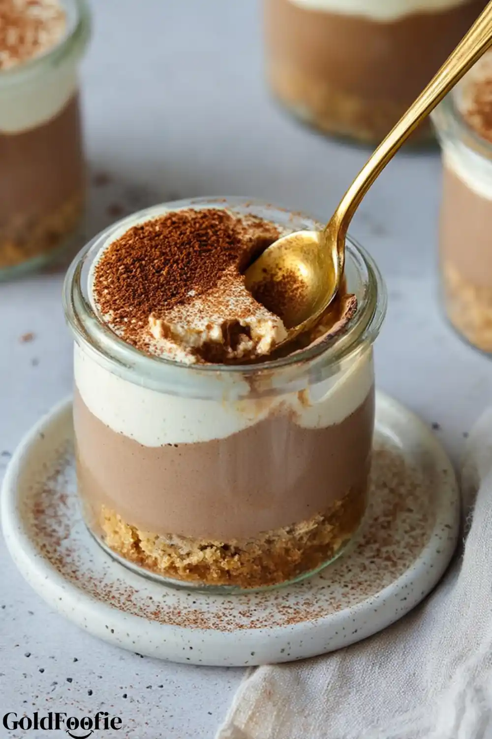 High-Protein Tiramisu Chia Delight Gold spoon scooping into tiramisu chia pudding