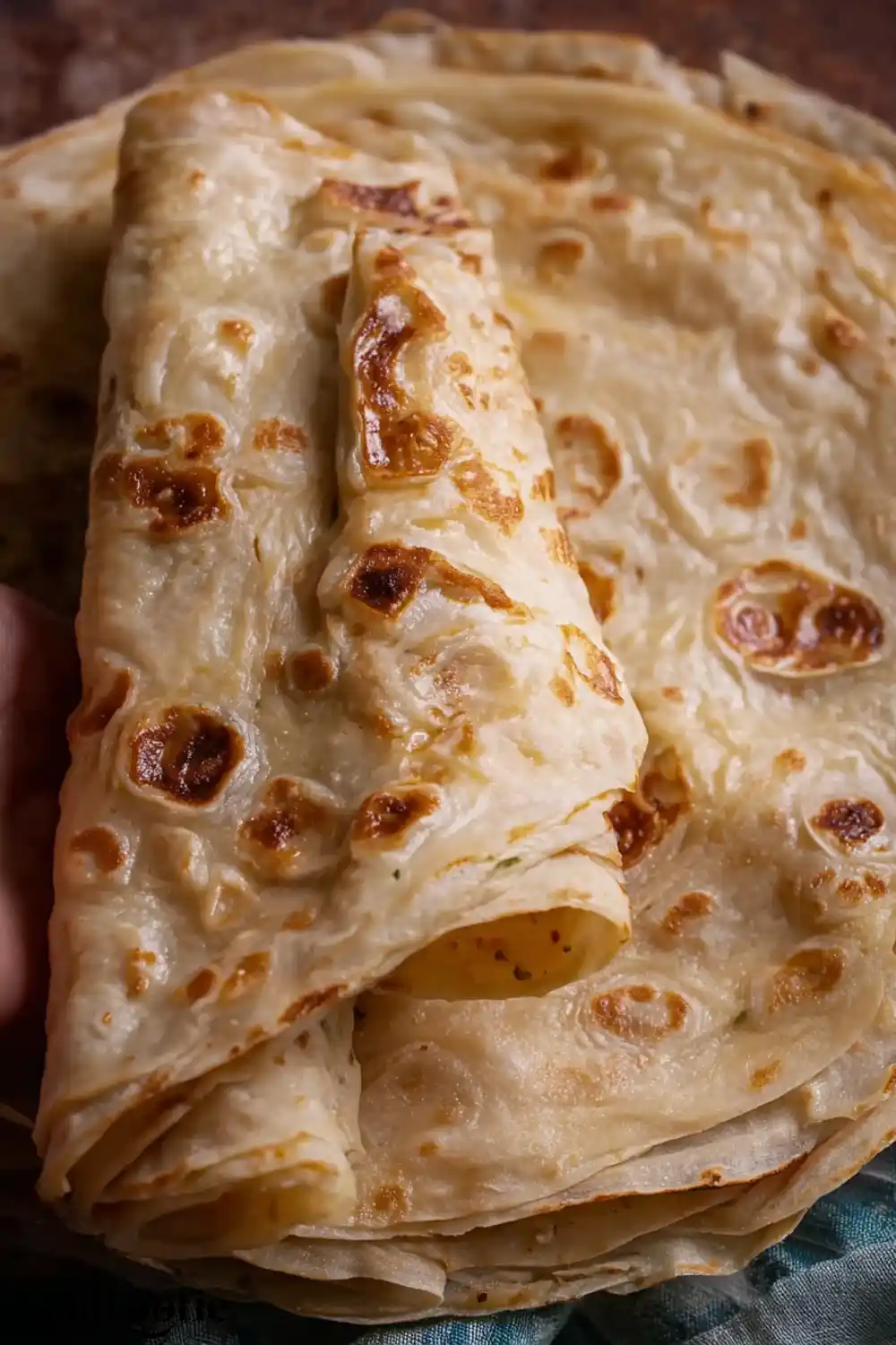 Perfect Burrito Tortilla: Soft, Chewy, Homemade 6 Rolled and flat homemade tortillas with beautifully toasted brown spots.