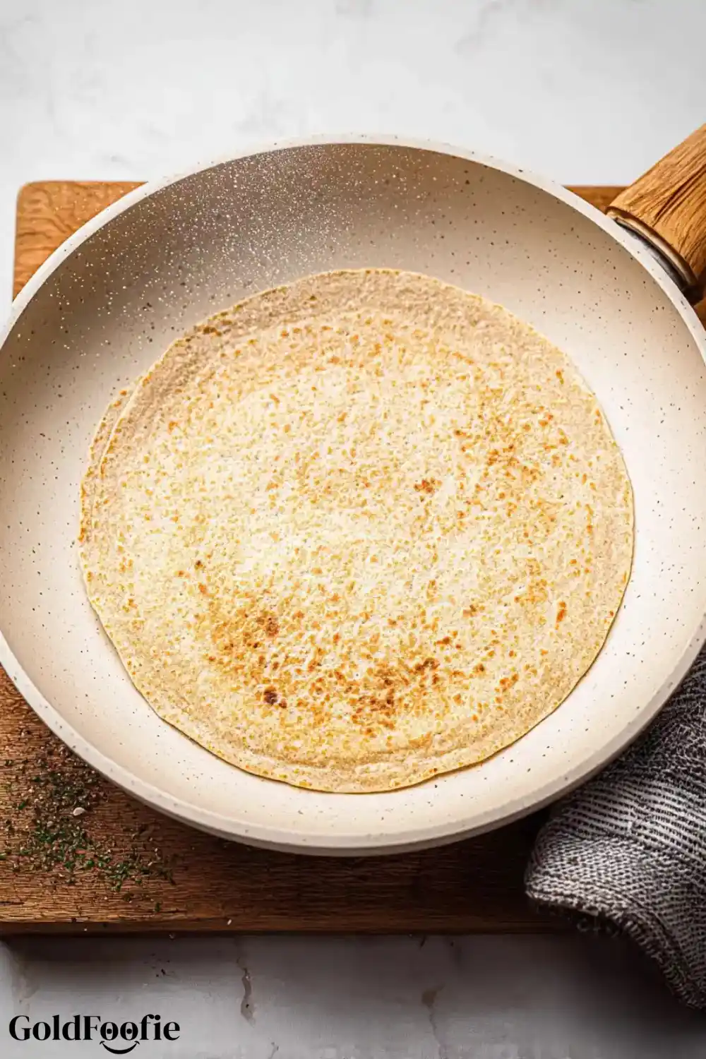 Oat Tortilla in Skillet Golden oat tortilla cooking in non-stick pan