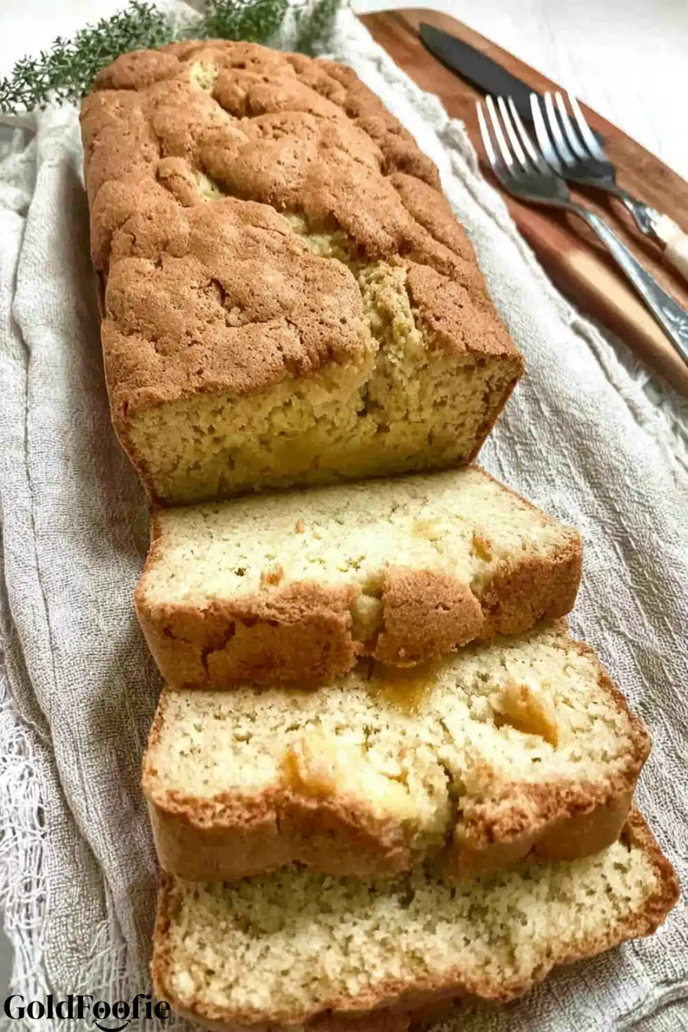 Perfectly Sliced Lupin Bread A sliced loaf of keto lupin bread on a light gray cloth next to a knife and fork.