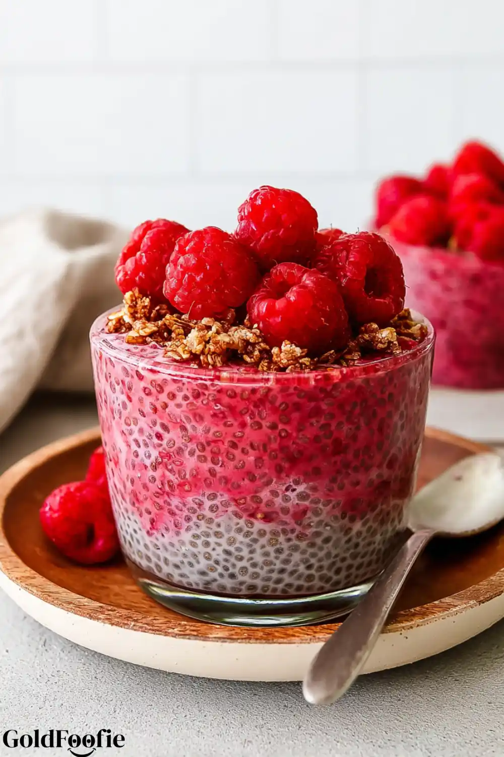 Protein-Packed Raspberry Chia Raspberry chia pudding topped with granola and fresh raspberries