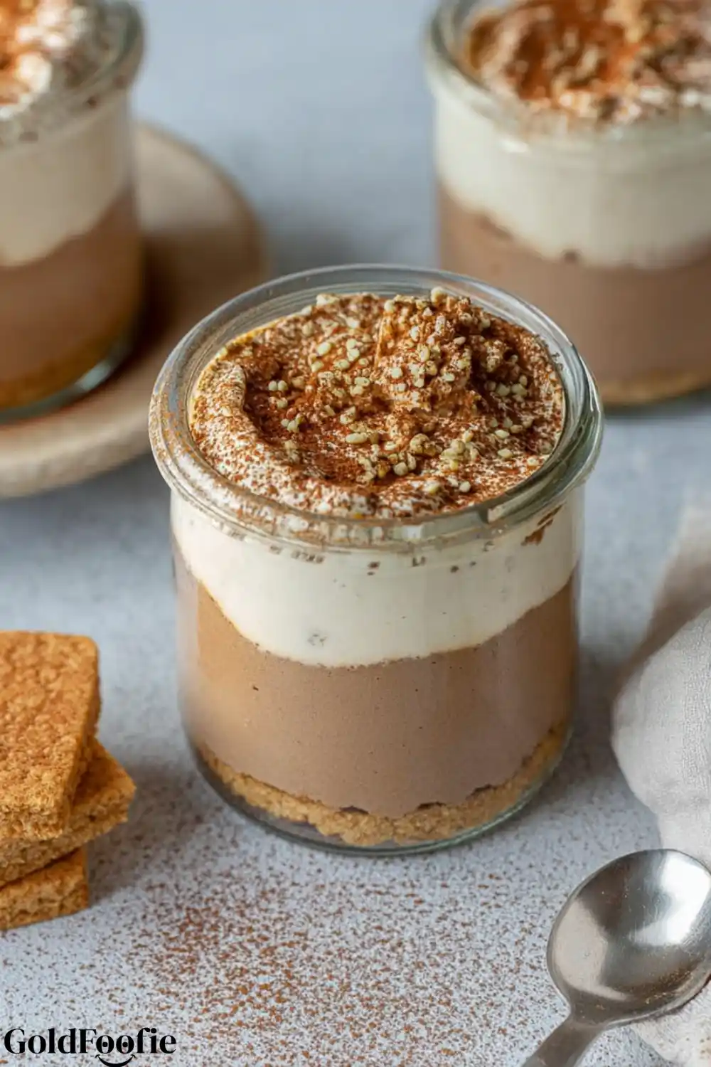 Protein-Packed Tiramisu Chia Layer Glass jar of tiramisu chia pudding topped with puffed quinoa
