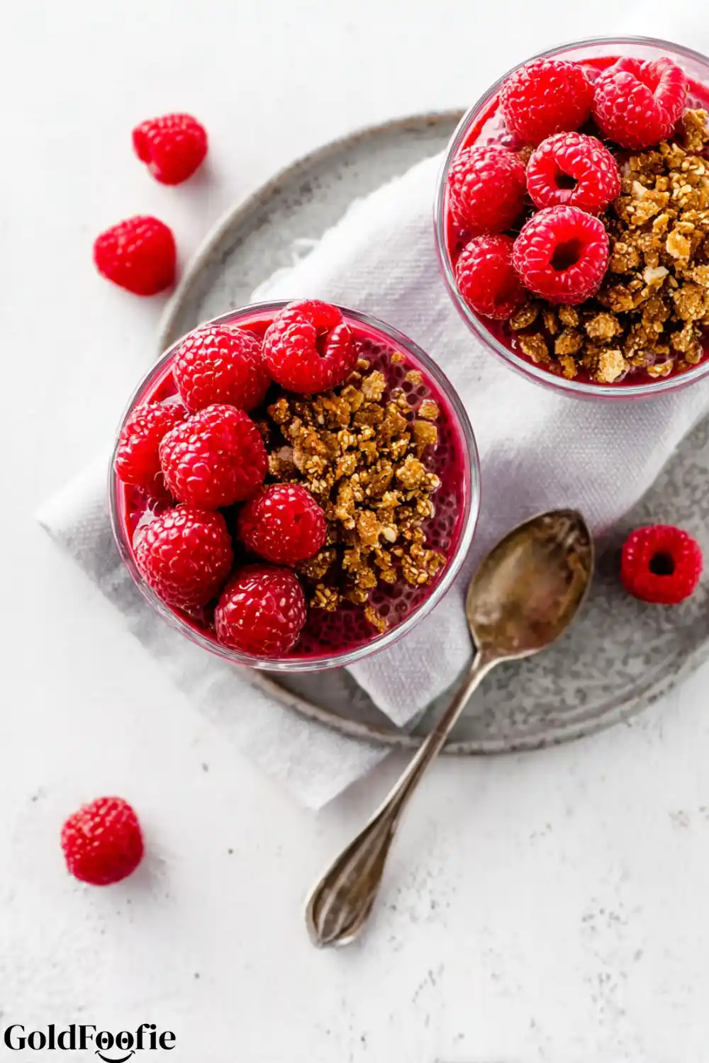 Raspberry Chia Parfait Bowls Overhead view of raspberry chia parfaits with spoons
