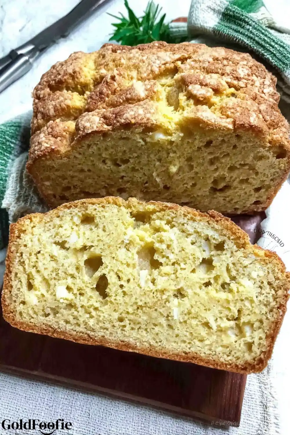 Lupin Flour Bread Fix for Your Keto Cravings Fast 5 A close-up of a rustic, cheesy lupin bread loaf sliced on a wooden board.