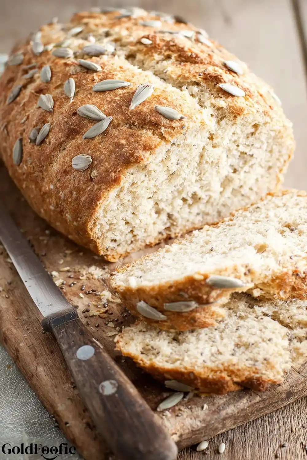 Diabetic Bread Recipes for Stable Blood Sugar 5 A sliced loaf of rustic, seeded bread next to a serrated knife on a cutting board.