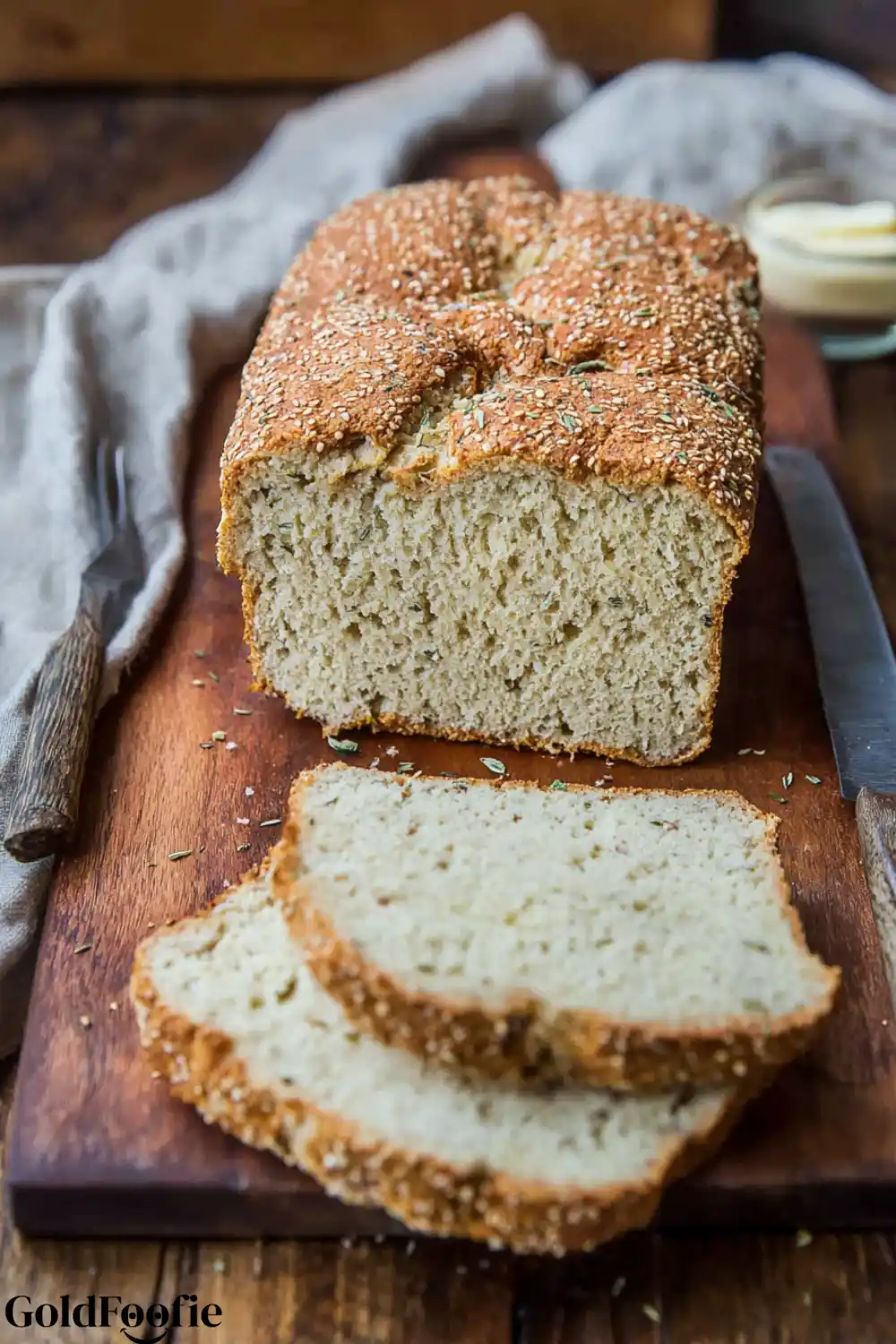 Sliced Low-Carb Coconut Bread A loaf of coconut flour bread on a cutting board with two slices cut from it.