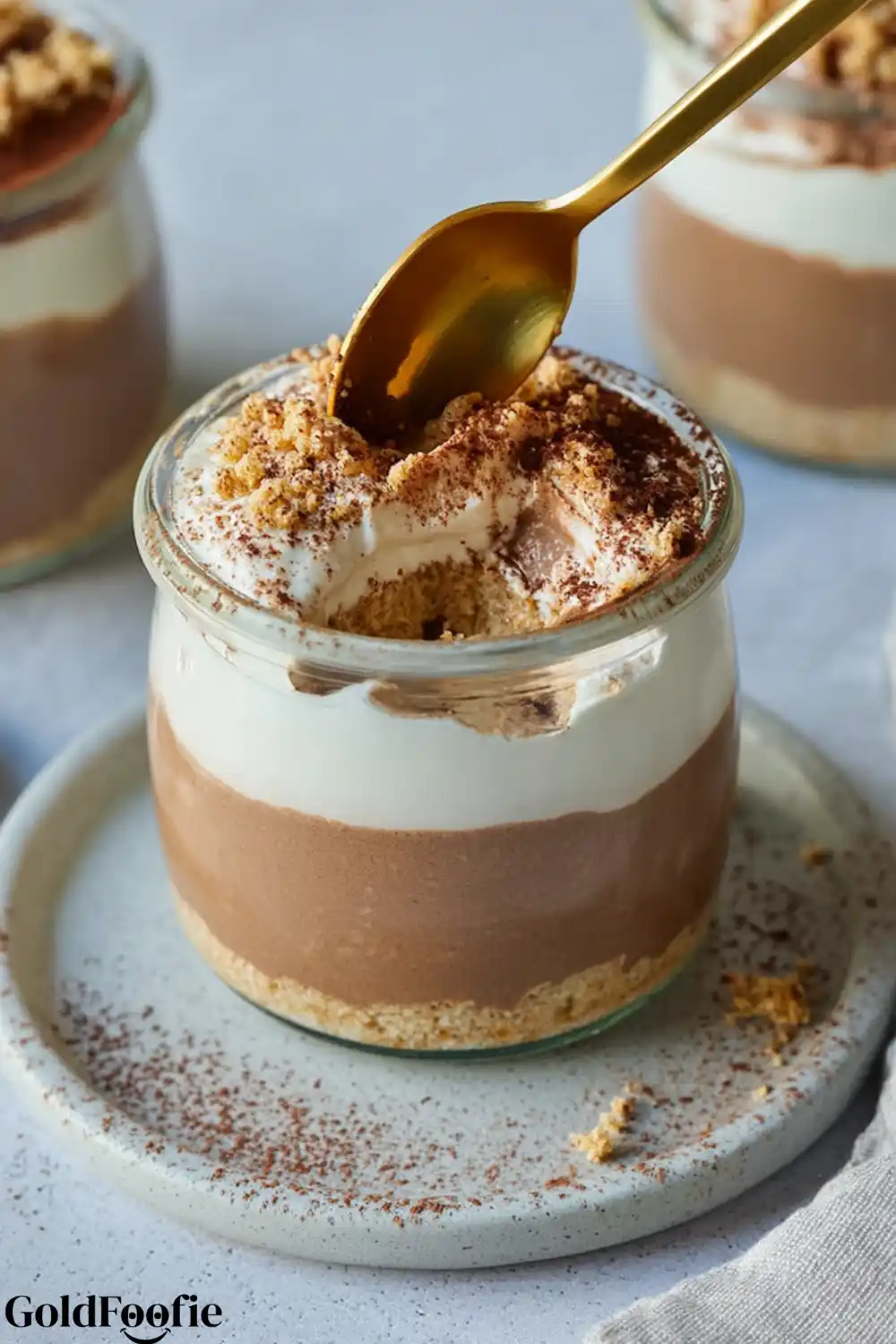 Easy Tiramisu Chia Pudding 5 Spoon dipped into creamy tiramisu chia pudding jar
