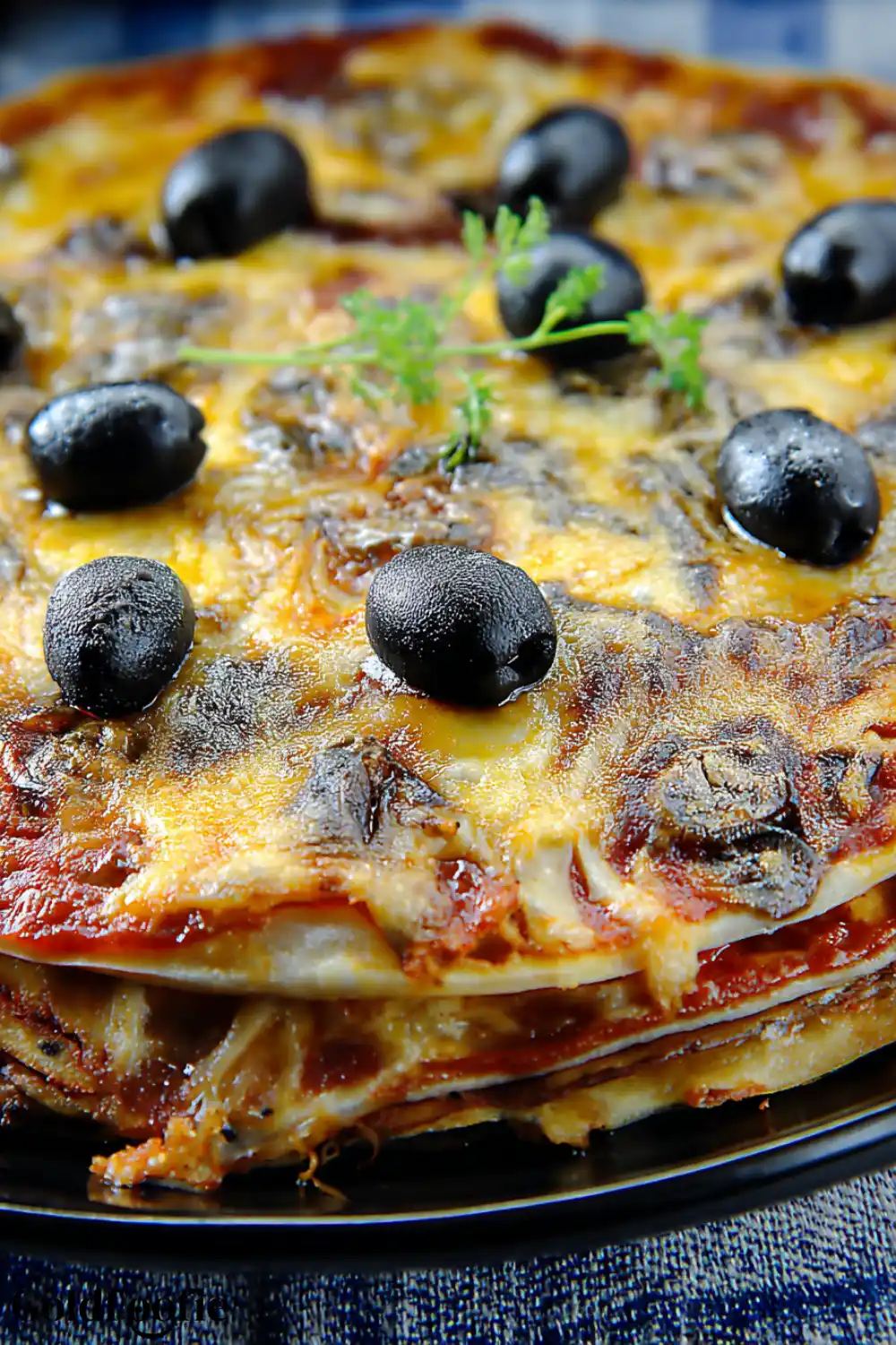 Crispy Pizza with Low Carb Tortilla Recipe 6 Multi-layered pizza made with low carb tortillas and topped with black olives and cheese