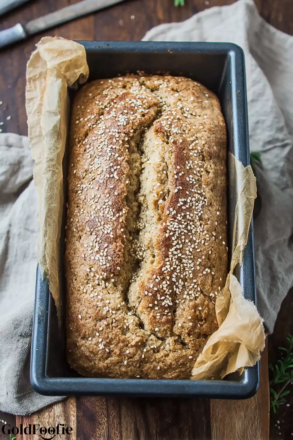 Top-Down View of Coconut Flour Bread An overhead view of a baked coconut flour bread in a parchment-lined pan.