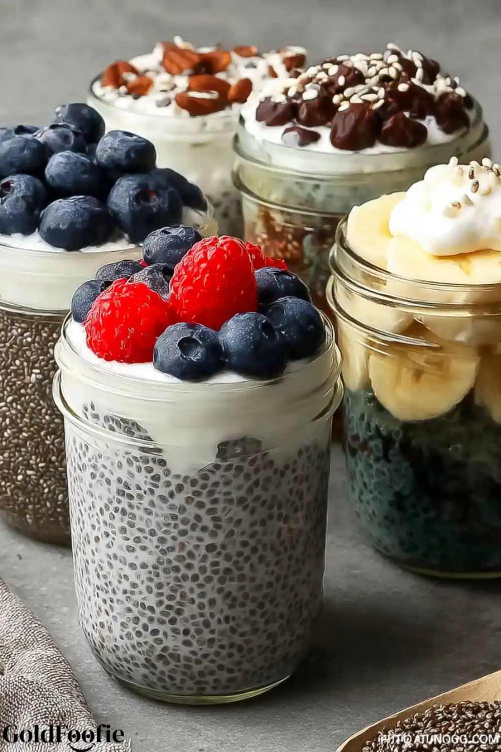 High-Protein Chia Pudding 5 Chia puddings with layers of fruit, nuts, and yogurt in clear jars