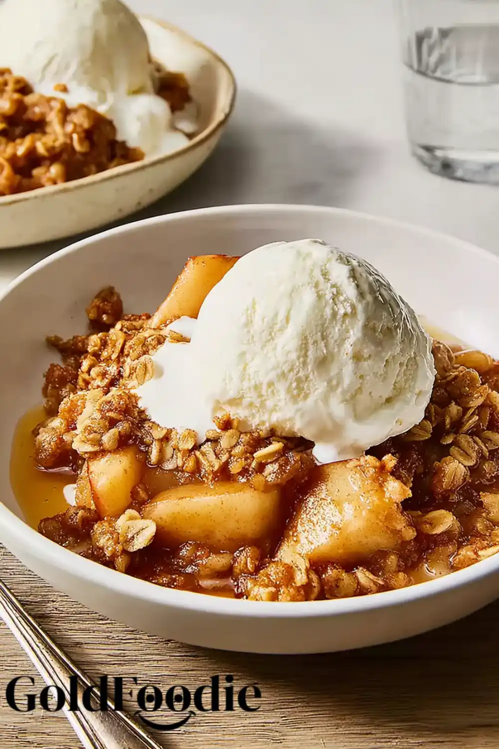 Apple Crisp Bowl with Ice Cream Apple crisp in white bowl with scoop of ice cream