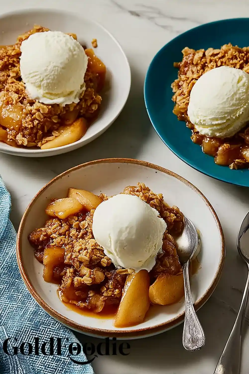 Apple Crisp Trio Ready to Serve Three plates of apple crisp with scoops of vanilla ice cream