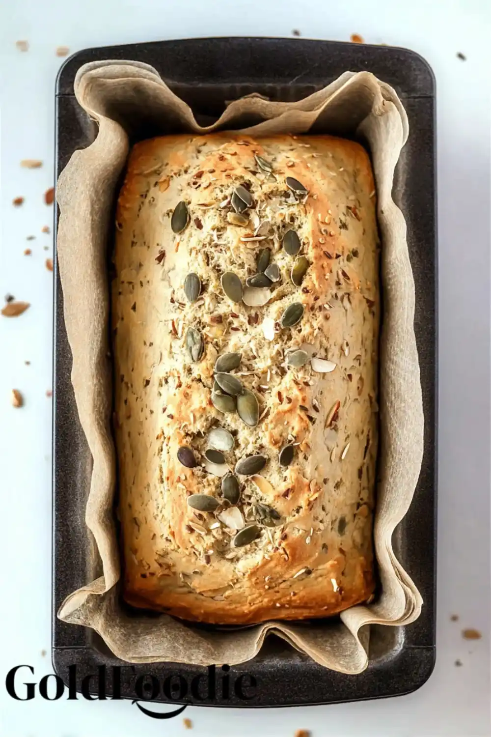 Baked Almond Bread Loaf Baked almond bread in loaf pan with seeds on top