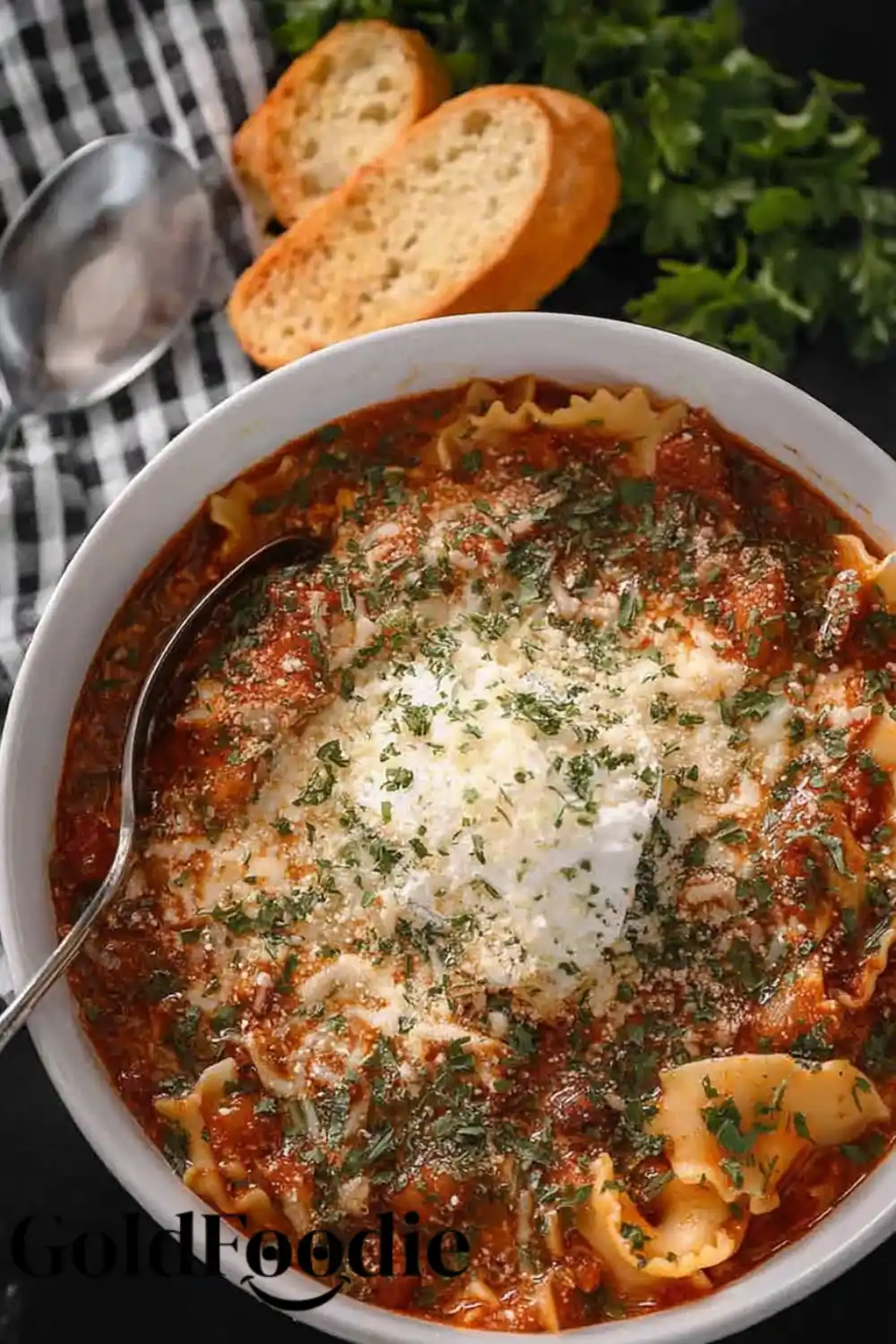 Bowl of Crockpot Lasagna Soup Bowl of lasagna soup topped with ricotta and herbs