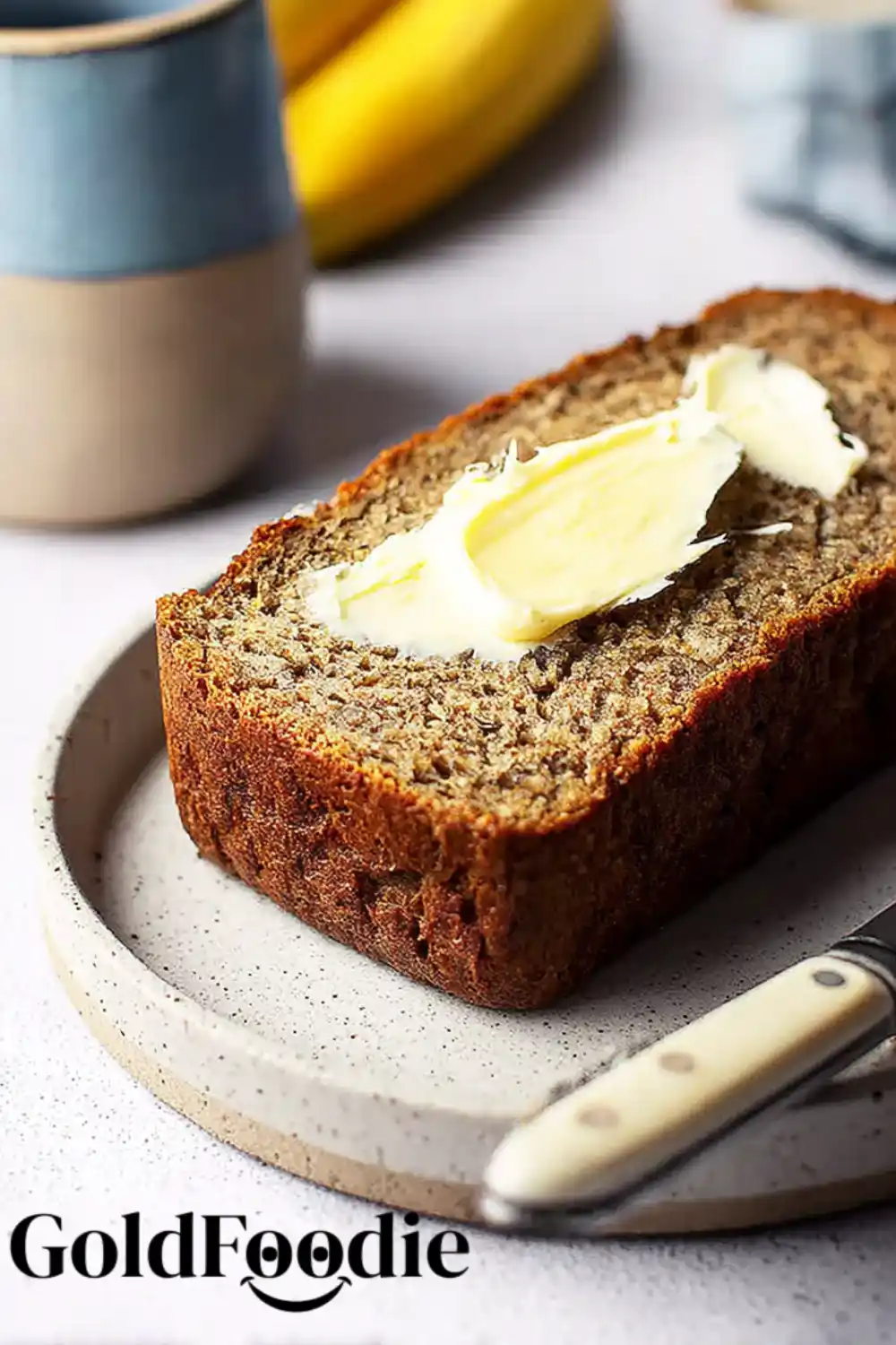 Buttered Coconut Banana Bread Slice Slice of Coconut Banana Bread with butter on a plate.