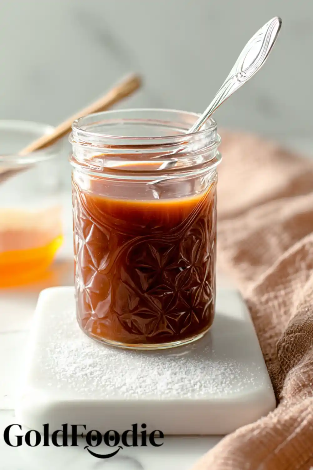 Caramel Sauce Jar of homemade bourbon caramel sauce with spoon