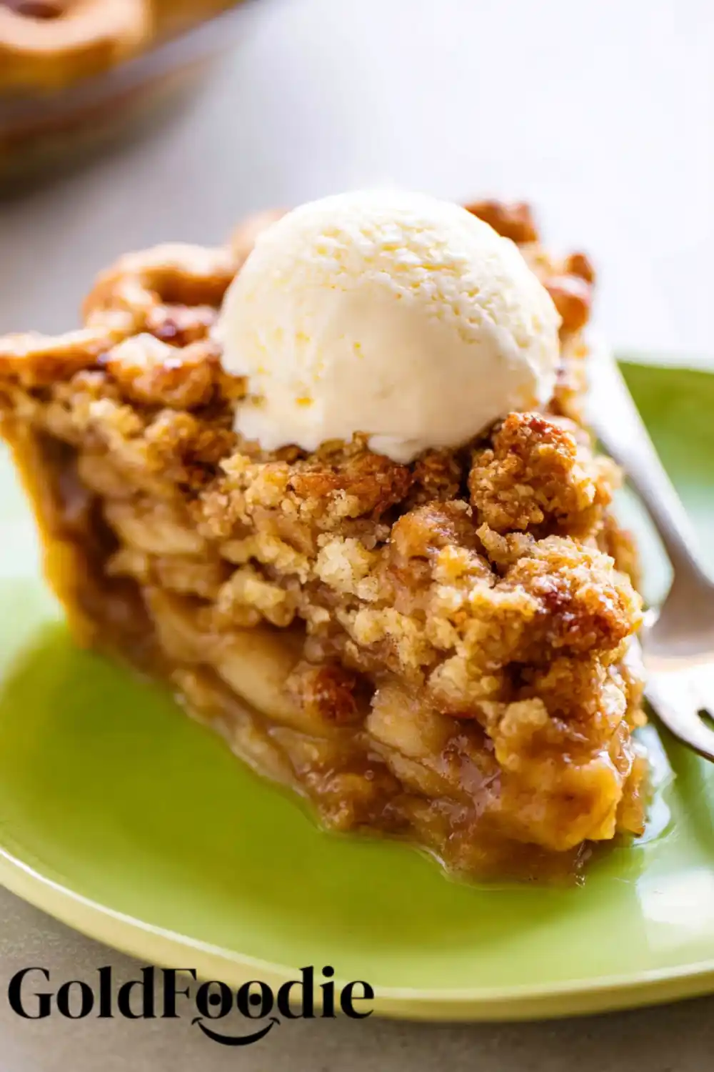 Deep Pie Slice Close-Up Deep slice of apple crumble pie on green plate