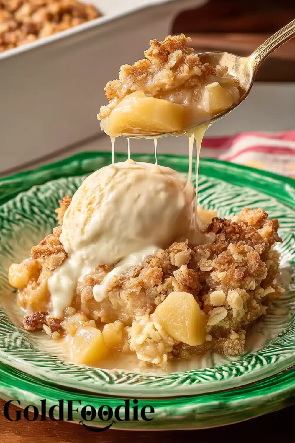 Drizzling Apple Crisp Spoonful of pioneer woman apple crisp dripping sauce over vanilla ice cream