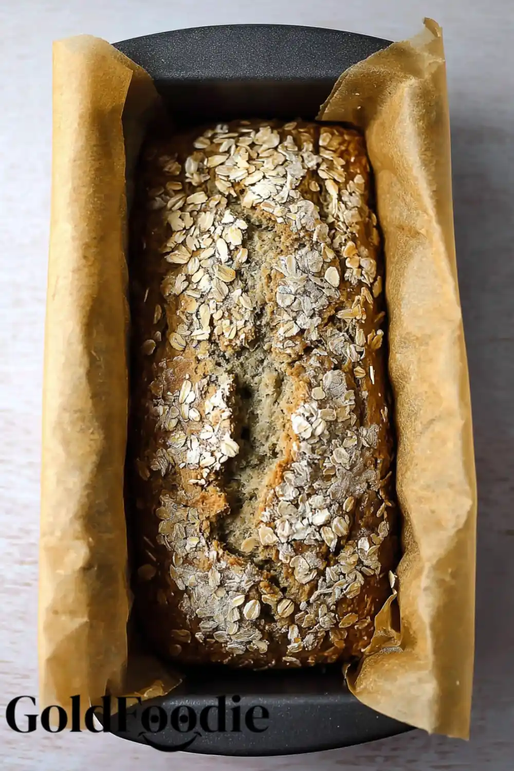 Fresh from the Oven Freshly baked oatmeal bread in a loaf pan.