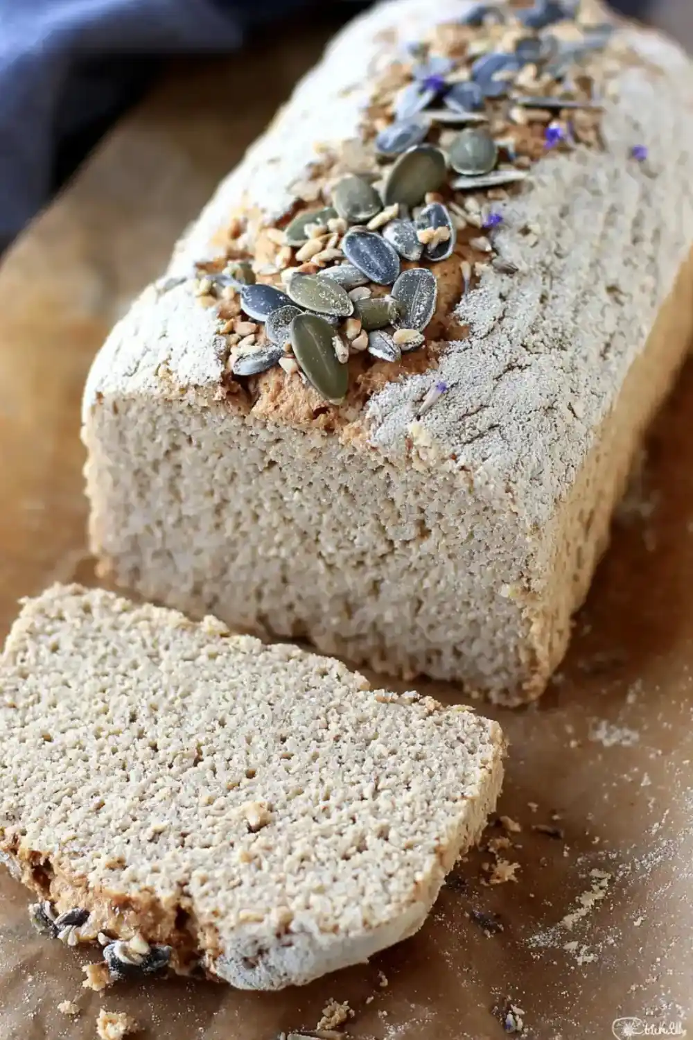 Golden Vegan Sunflower Bread Loaf of gluten-free sunflower bread topped with seeds
