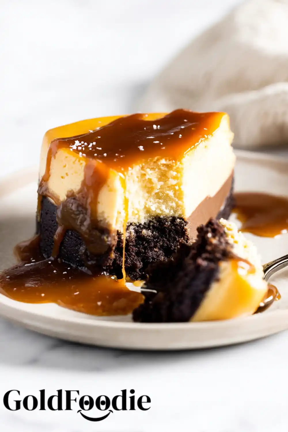 Gooey Caramel Brownie Cheesecake Cheesecake slice with brownie crust and caramel topping
