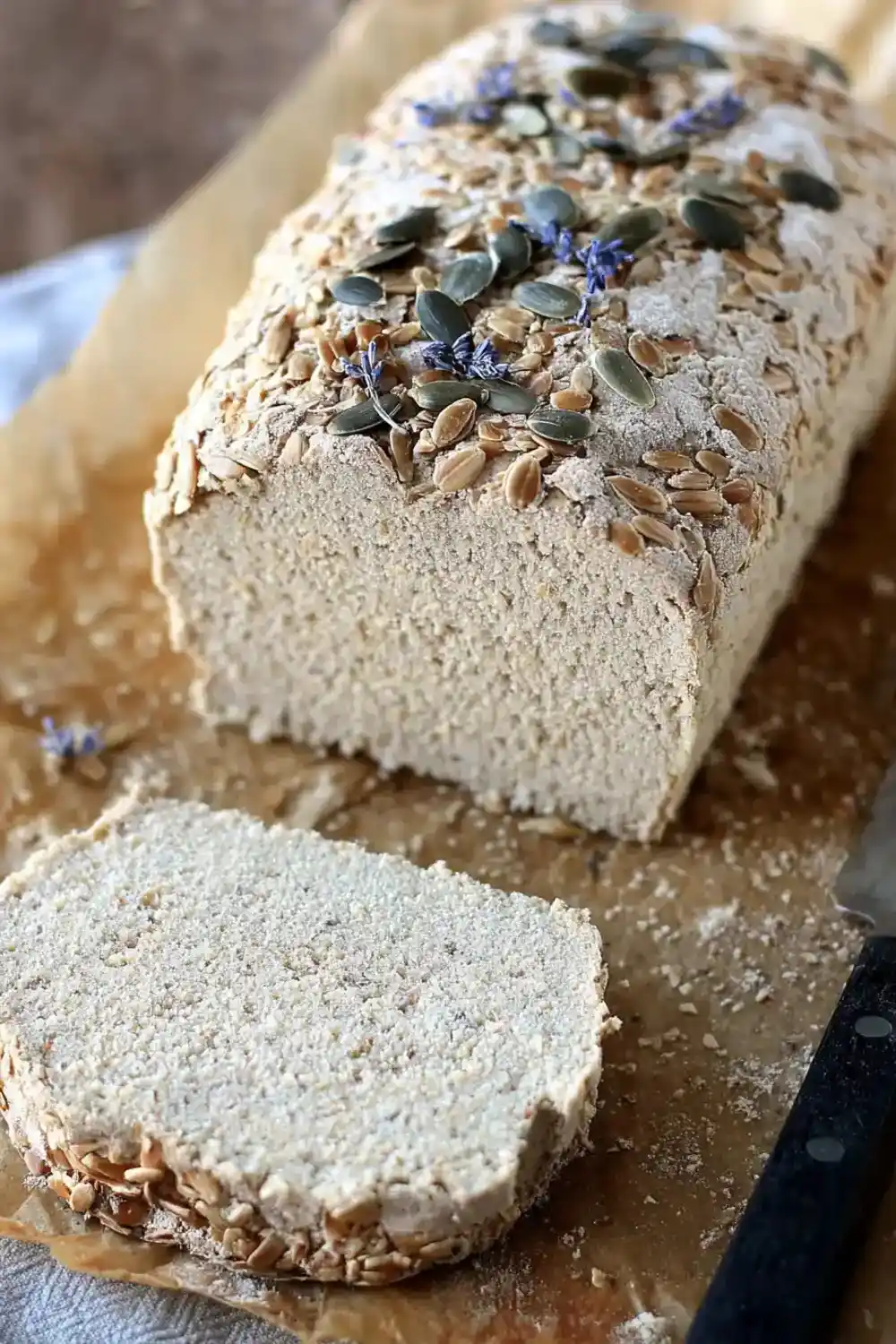Sunflower Seed Flour Bread Easy Healthy Recipe 5 Clean slice of sunflower seed bread beside full loaf