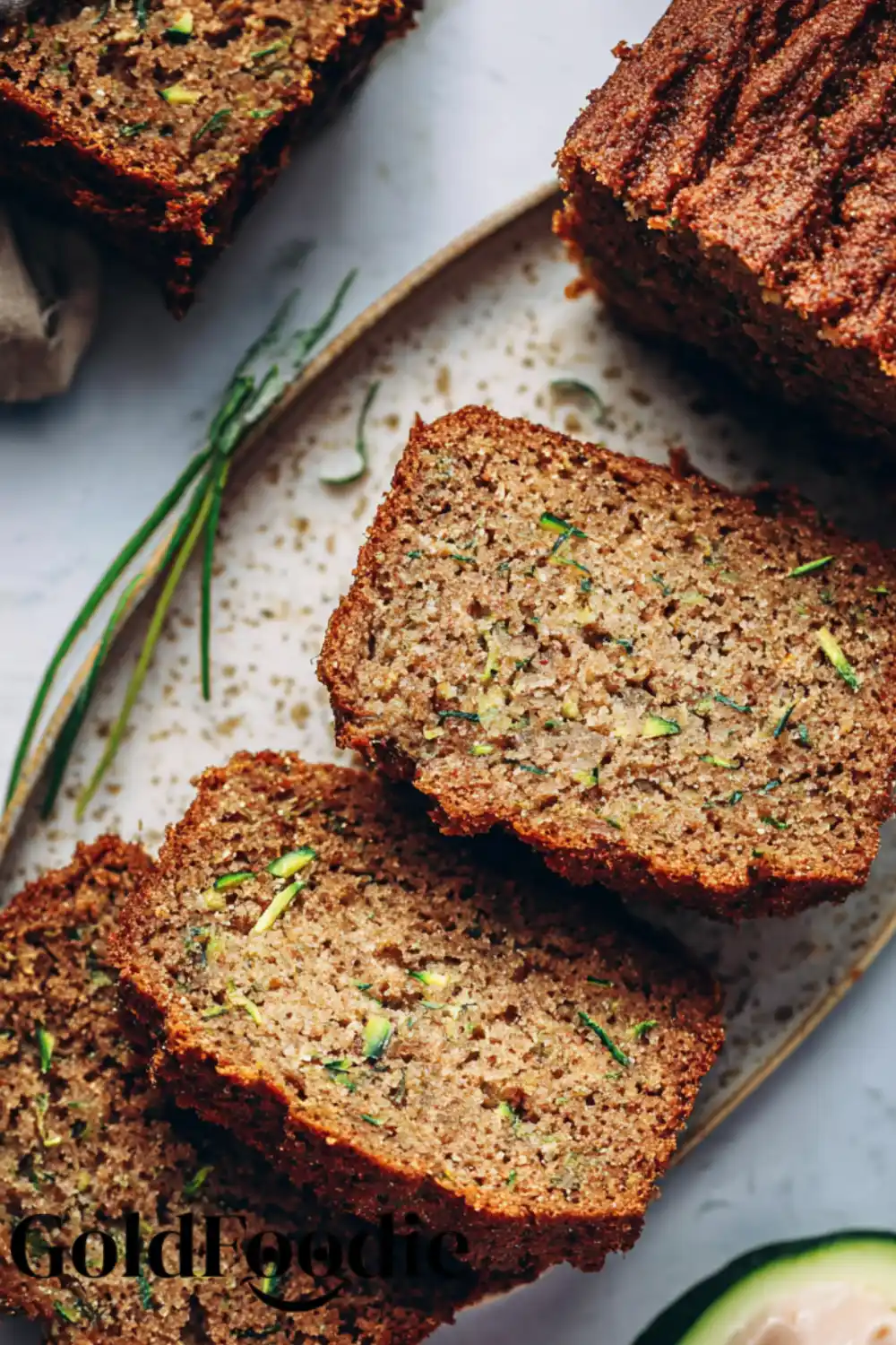 Healthy Zucchini Bread Snack Two slices of vegan zucchini bread on a decorative plate.