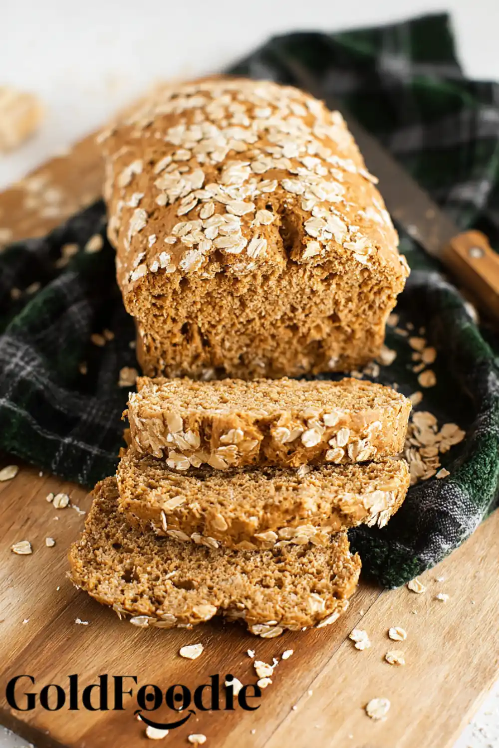 Homemade Oat Bread Gluten-free oat bread on cutting board with crumbs.