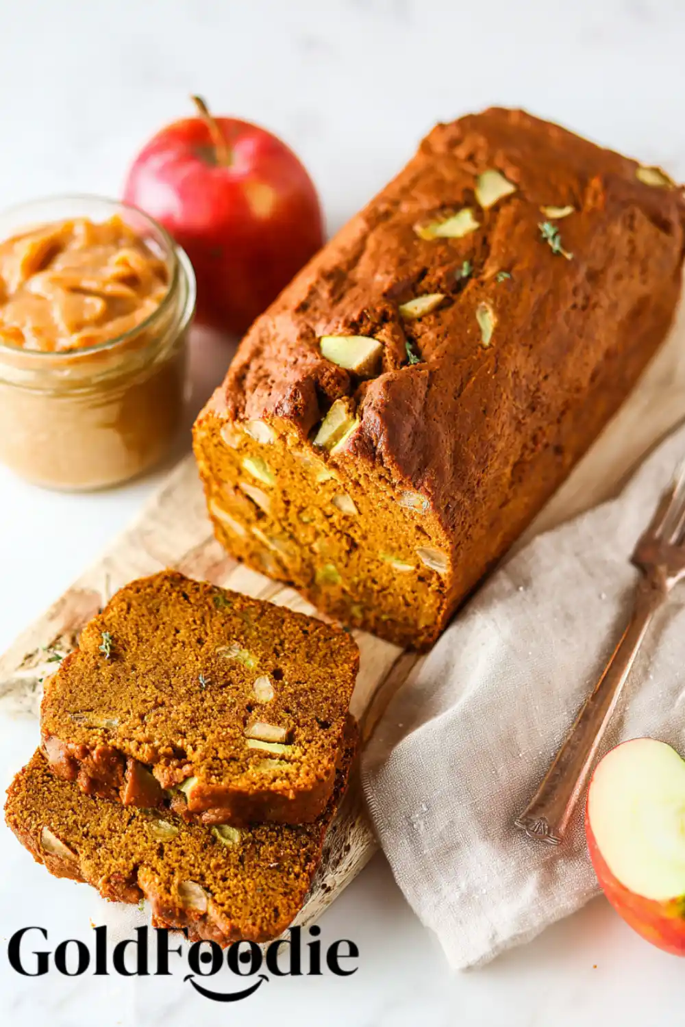 gluten free vegan pumpkin apple bread 5 A close-up of a sliced pumpkin apple bread loaf, showing the chunks of apple inside.